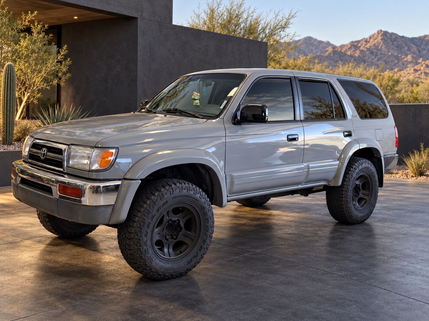 Toyota 4Runner, Silver finish · Off-road stance, with an edited architectural desert background